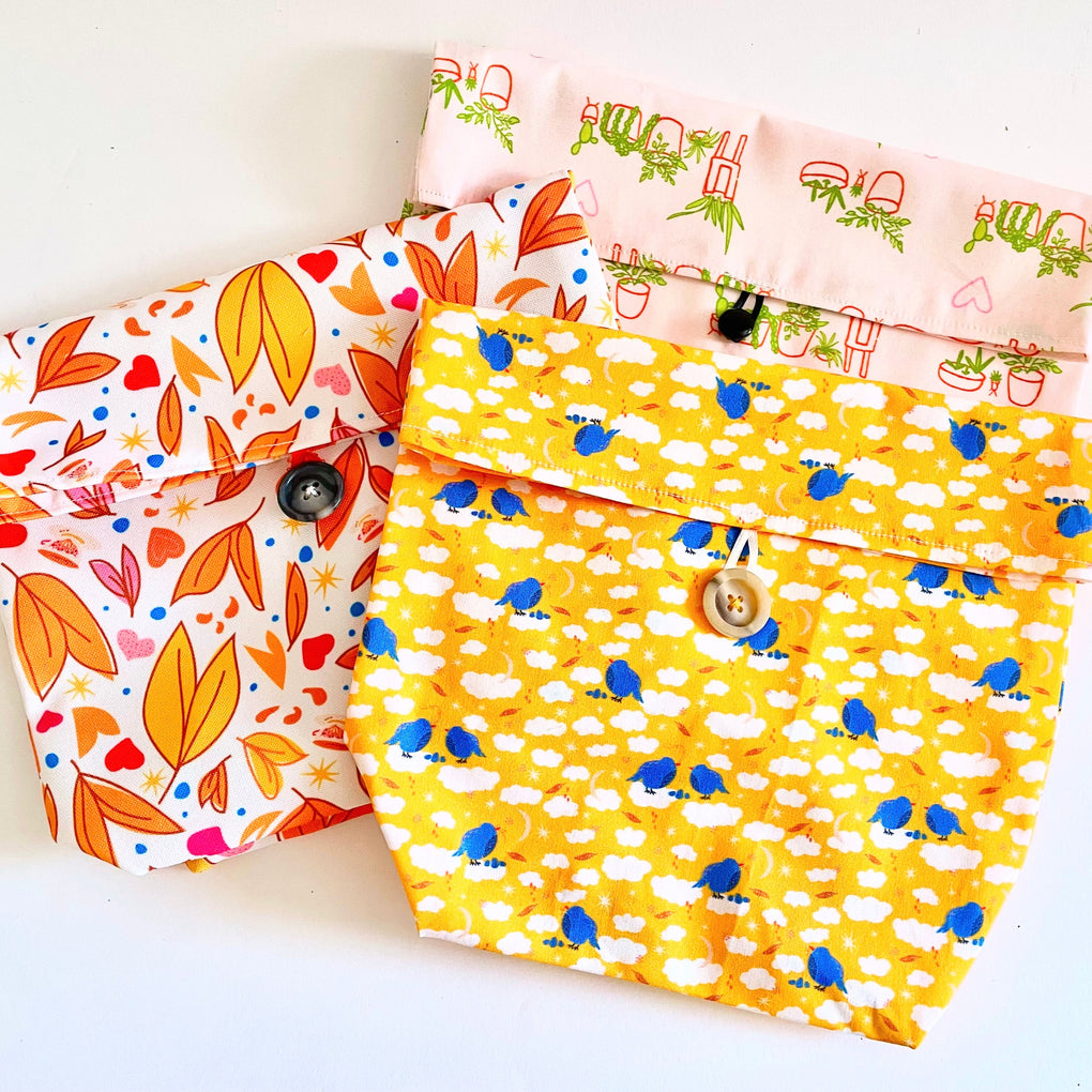 Three fabric bags with colorful patterns on a white background